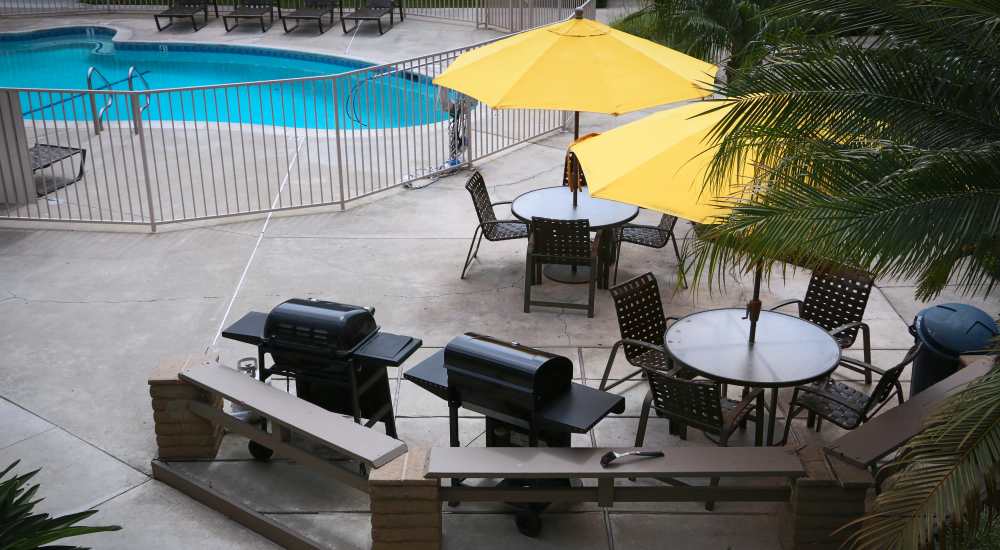 Poolside view with BBQ at Sandpointe in Huntington Beach, California