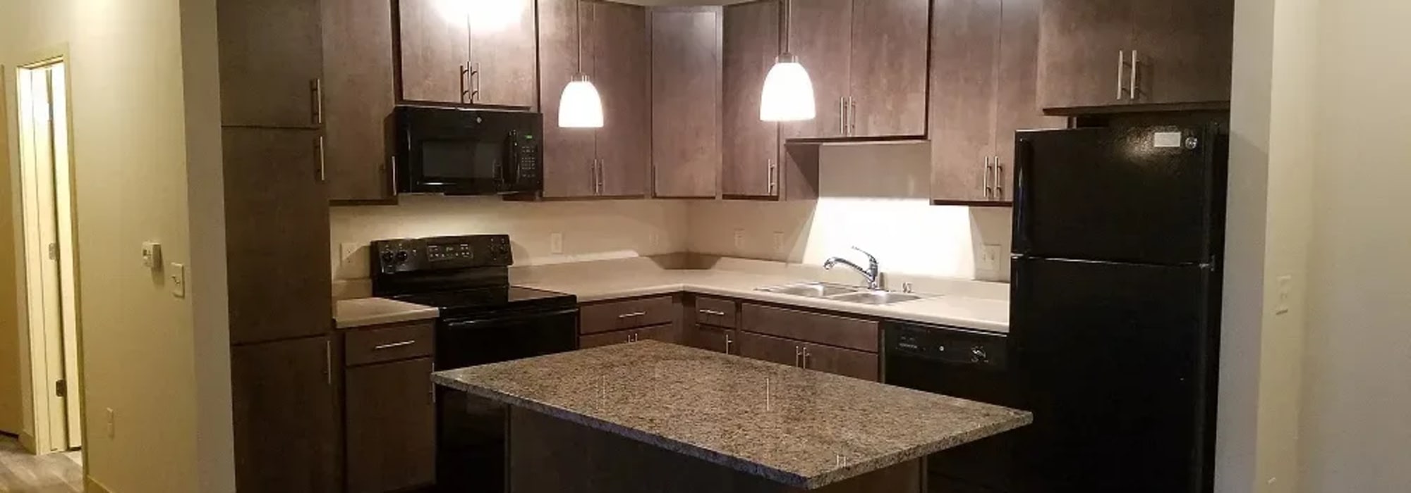 Modern kitchen with energy-efficient appliances at Mill Creek Apartments in Cross Plains, Wisconsin