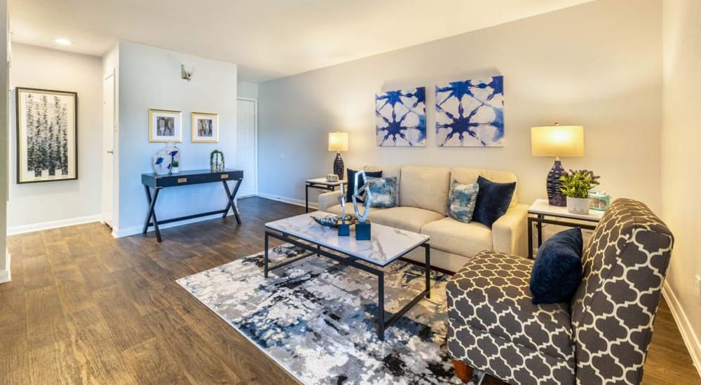 Resident living space with wood-style flooring at The Beverly at Clear Lake in Houston, Texas