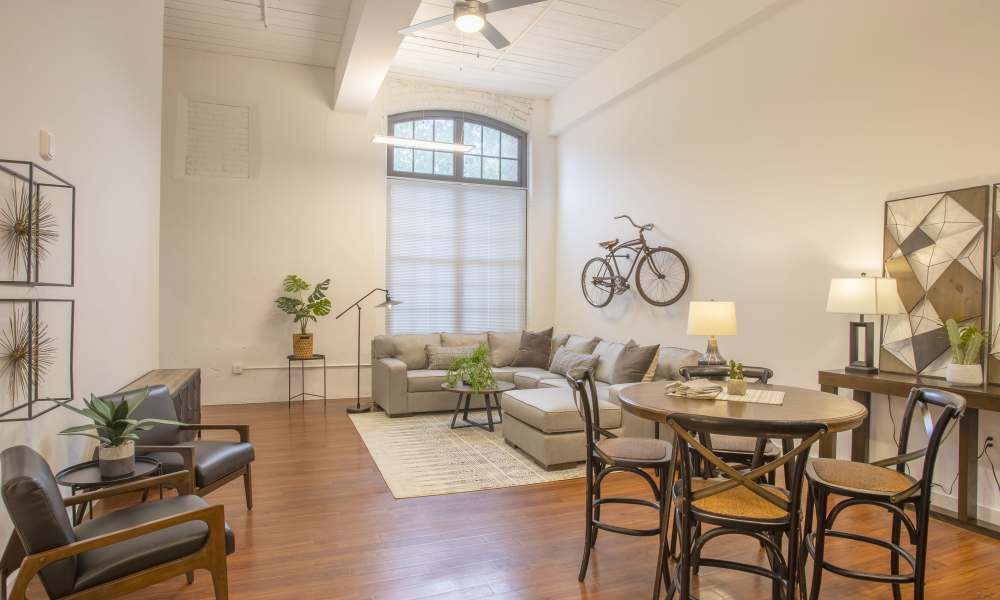 Dining space and seating area of the living room of an apartment at Lofts at Inman Mills in Inman, South Carolina