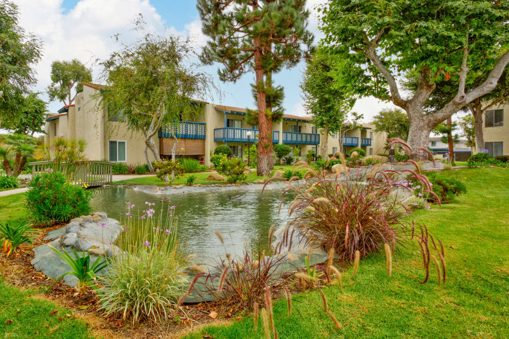 Pond and garden with exterior of buildings at The Landing at Channel Islands in OxnardCA