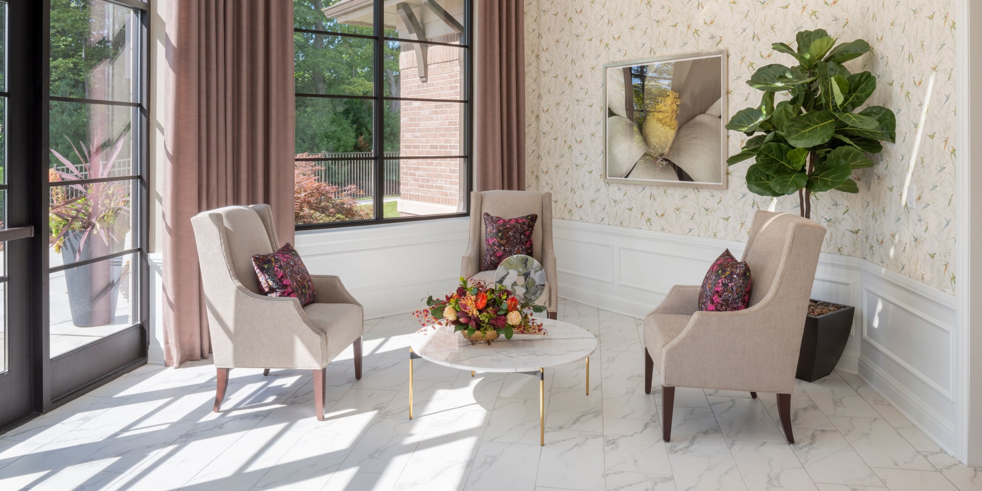 Elegant white seating with large sun window at Blossom Collection in Rochester, Michigan