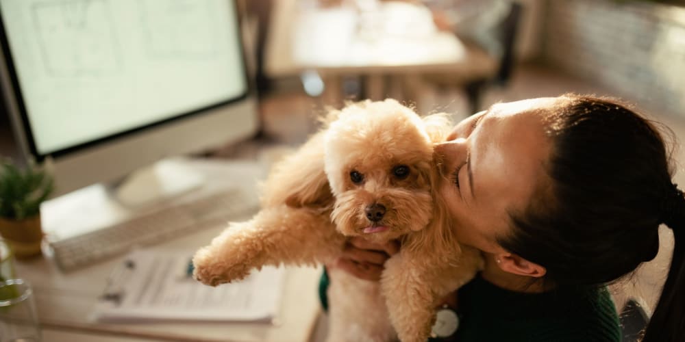 Resident kissing her pet at The Grant in Atlanta, Georgia