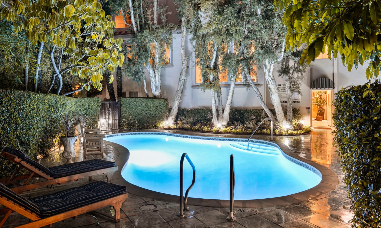 Underwater lights illuminating the pool in the evening at L'Estancia in Studio City, California