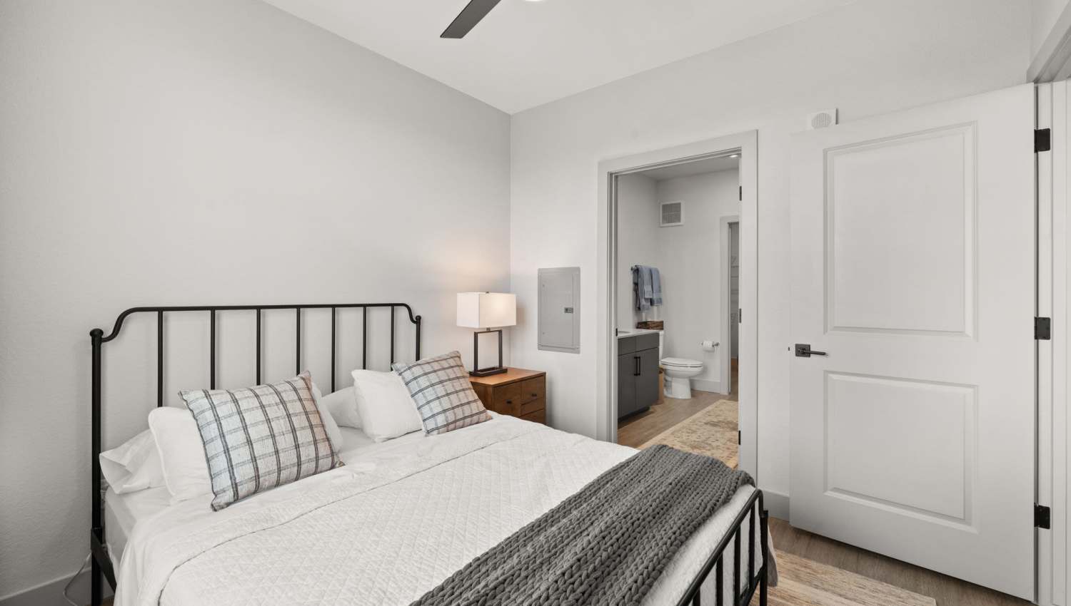 Spacious bedroom with connecting bathroom at The Lock at Flatirons in Broomfield, Colorado