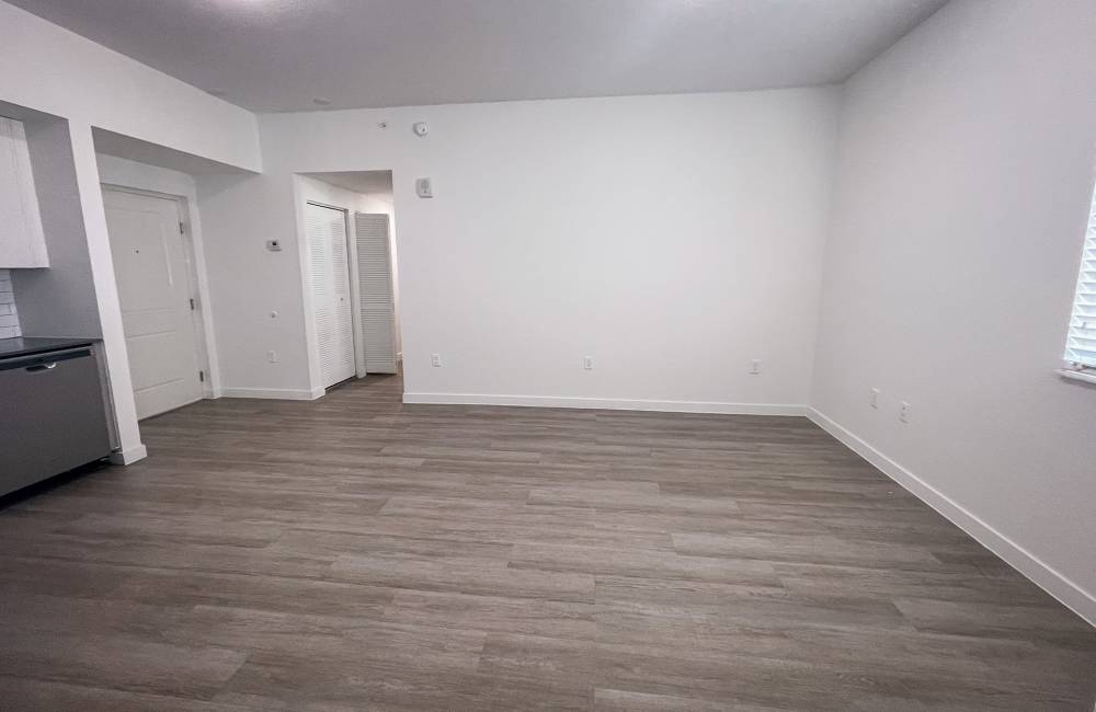 Living room with wood-style flooring at Park Apartments in Homestead, Florida