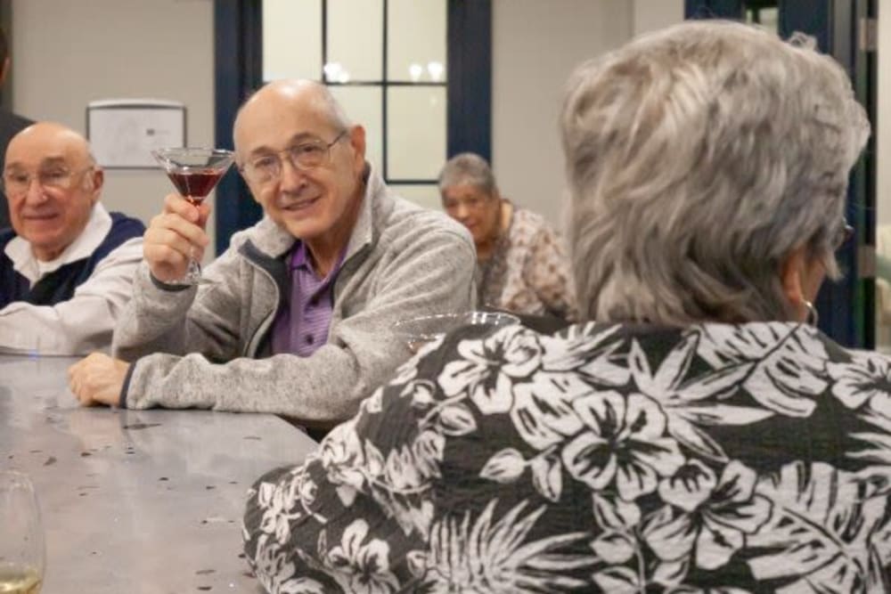 A resident toasting a drink at the pub at Mercer Hill at Doylestown in Doylestown, Pennsylvania