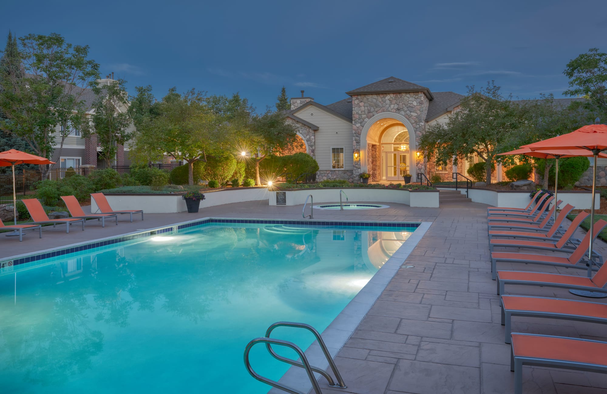 Sunset pool view with lounge chairs in Aurora, CO