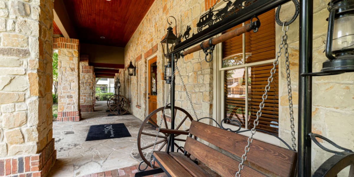 Antique swing bench outside main entrance of Marquis at Bellaire Ranch in Fort Worth, Texas