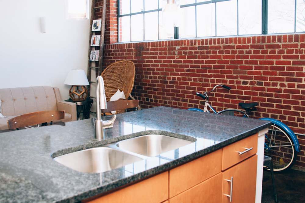 Open layout with granite countertops and bicycles at Courtyard Lofts at Scott’s Addition in Richmond, Virginia
