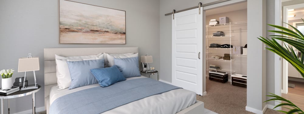 A comfortable master bedroom with oversized closet at Hawthorne Hill Apartments in Thornton, Colorado