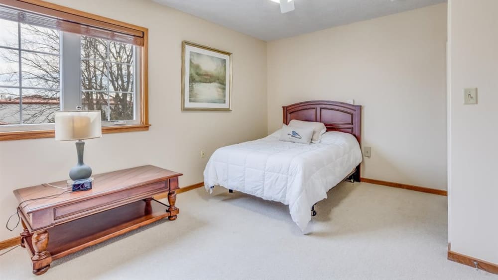 Apartment bedroom with ceiling fan and full size bed at Oxford Vista Wichita in Wichita, Kansas