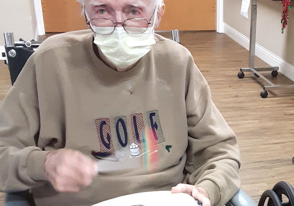 Resident playing a small timpani drum at Ingleside Communities in Mount Horeb, Wisconsin