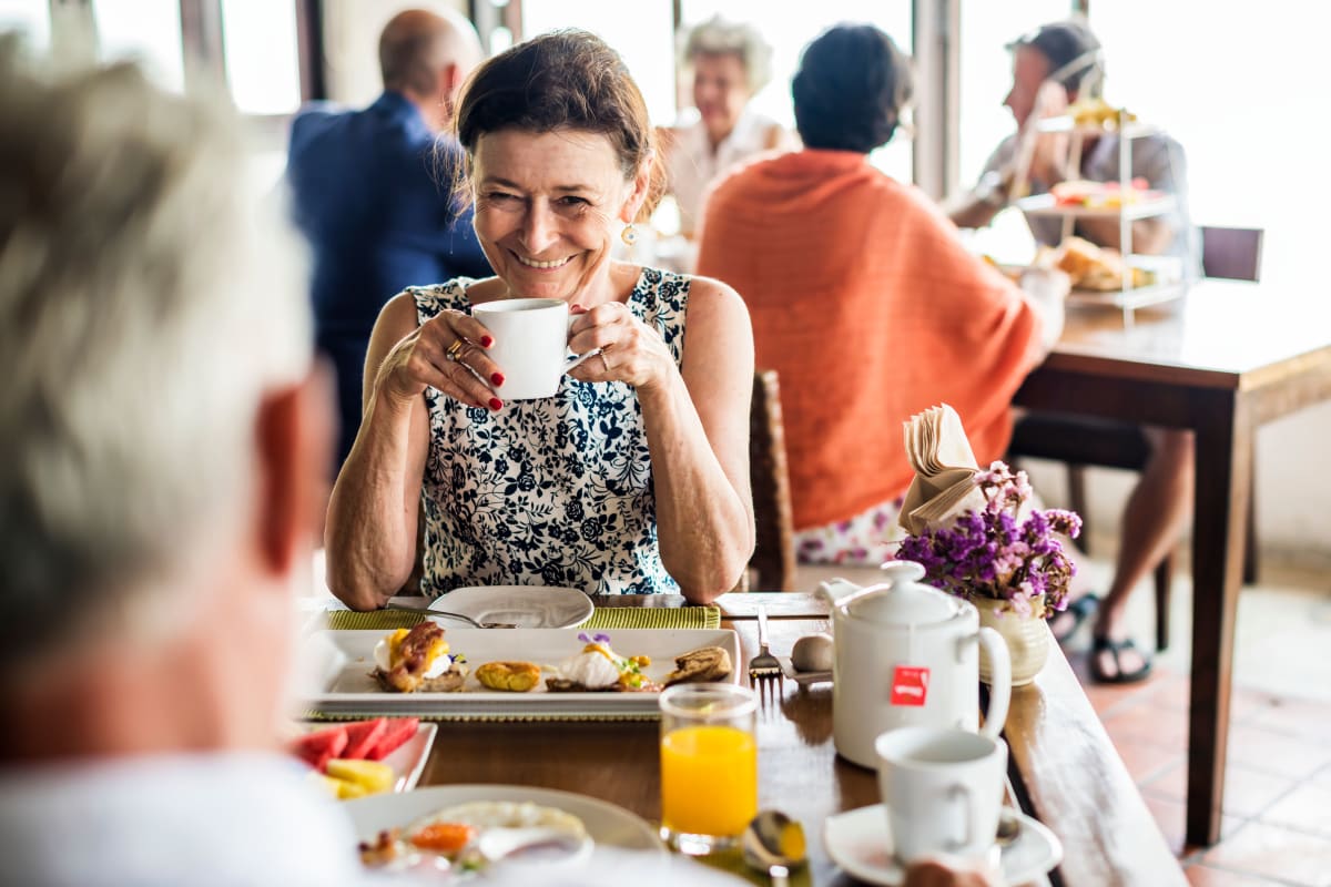 Resident eating breakfast with a friend at Keystone Commons in Ludlow, Massachusetts