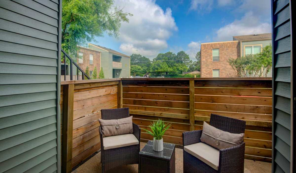 Private balcony with cozy seating area at University Green Apartments in Houston, Texas