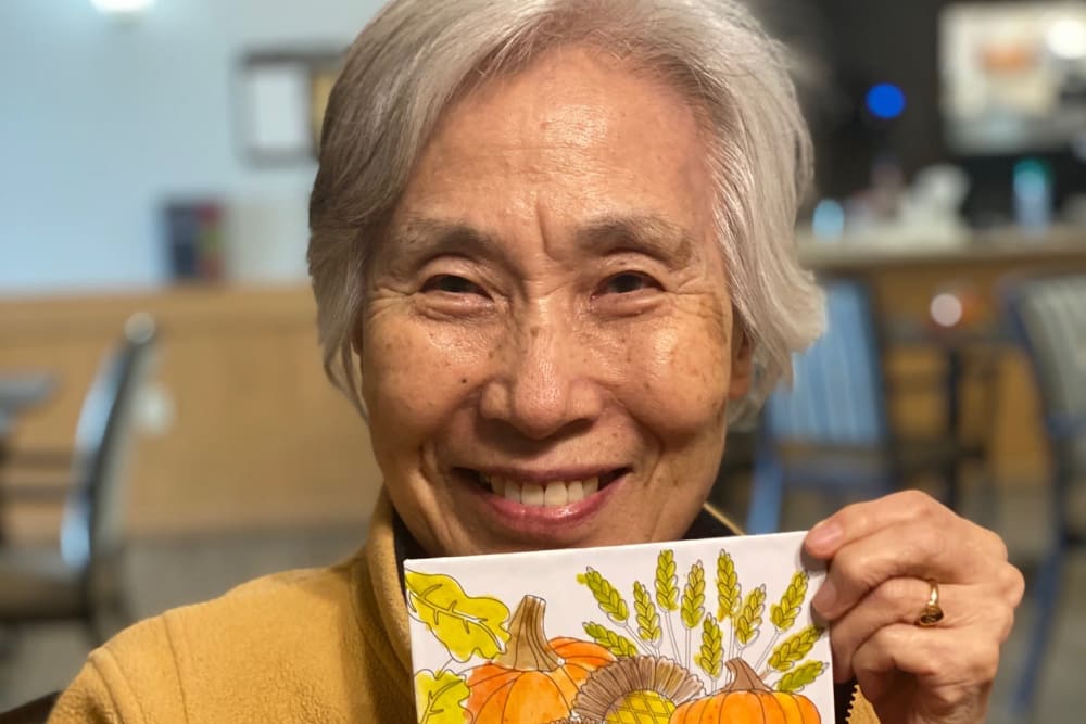 Resident displaying her artwork at Apple Creek Place in Appleton, Wisconsin