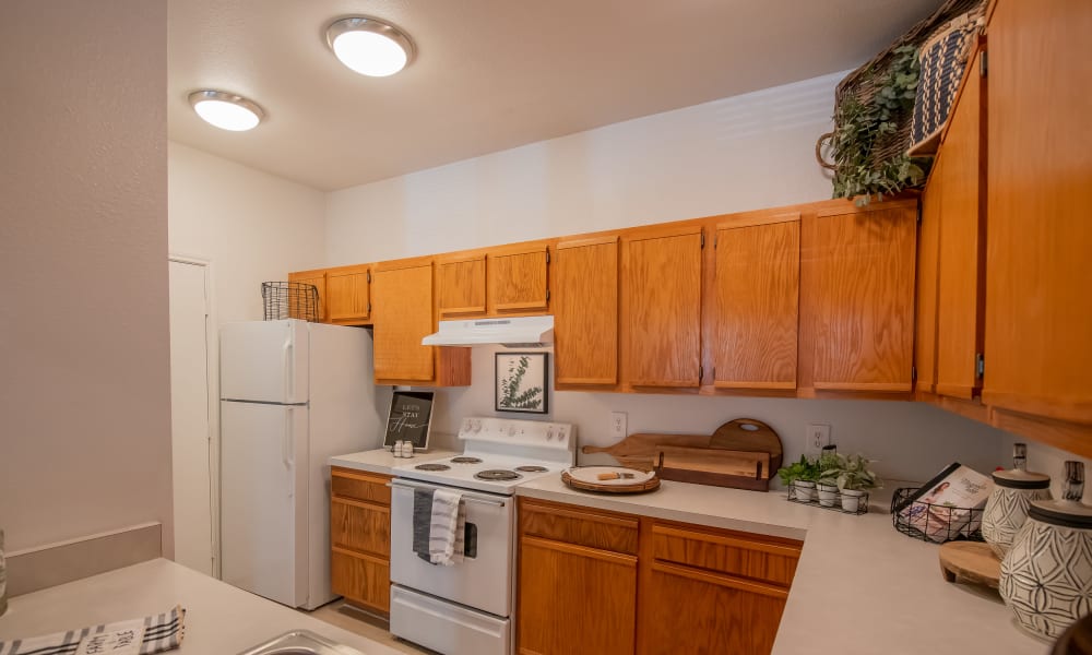 Spacious kitchen with granite countertops and light cabinetry at The Pointe of Ridgeland in Ridgeland, Mississippi