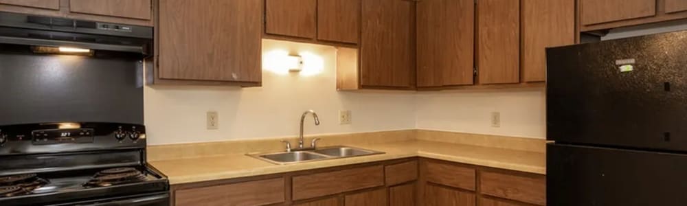 Kitchen with black appliances at Tanglewood Apartments in Hammond, Indiana