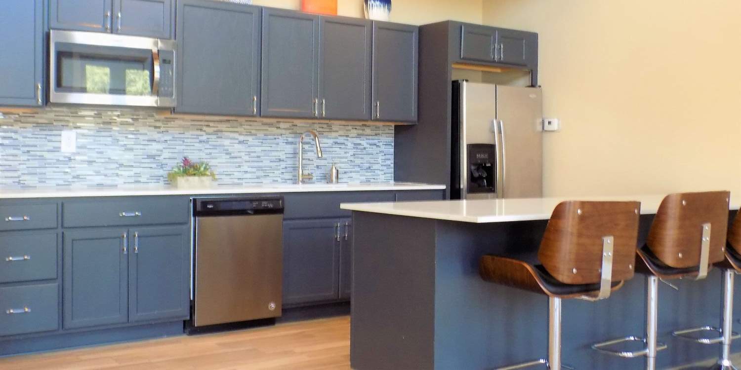 Kitchen with wooden cabinets at Branch Creek Apartments in Carrollton, Texas