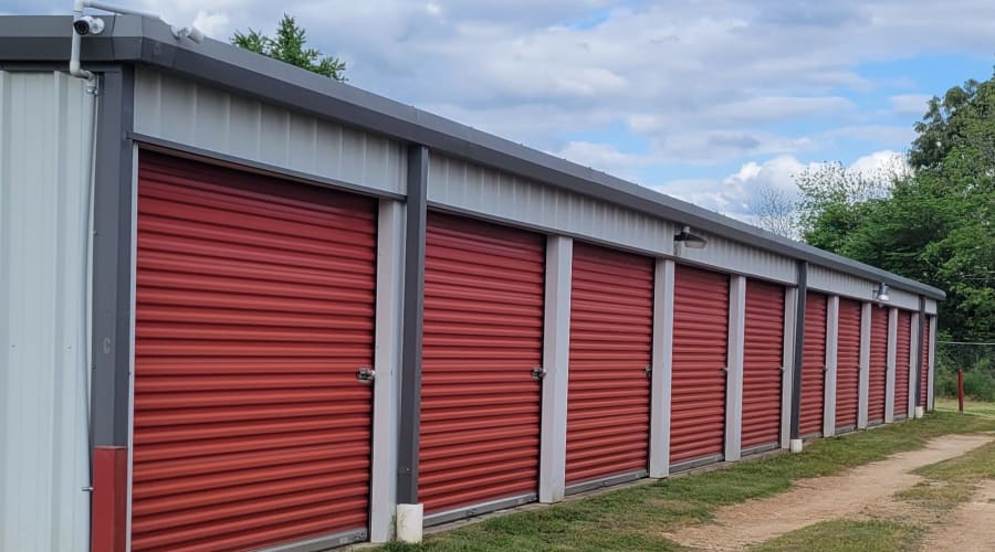 A family carrying storage boxes into their new home near KO Storage in Gilmer, Texas