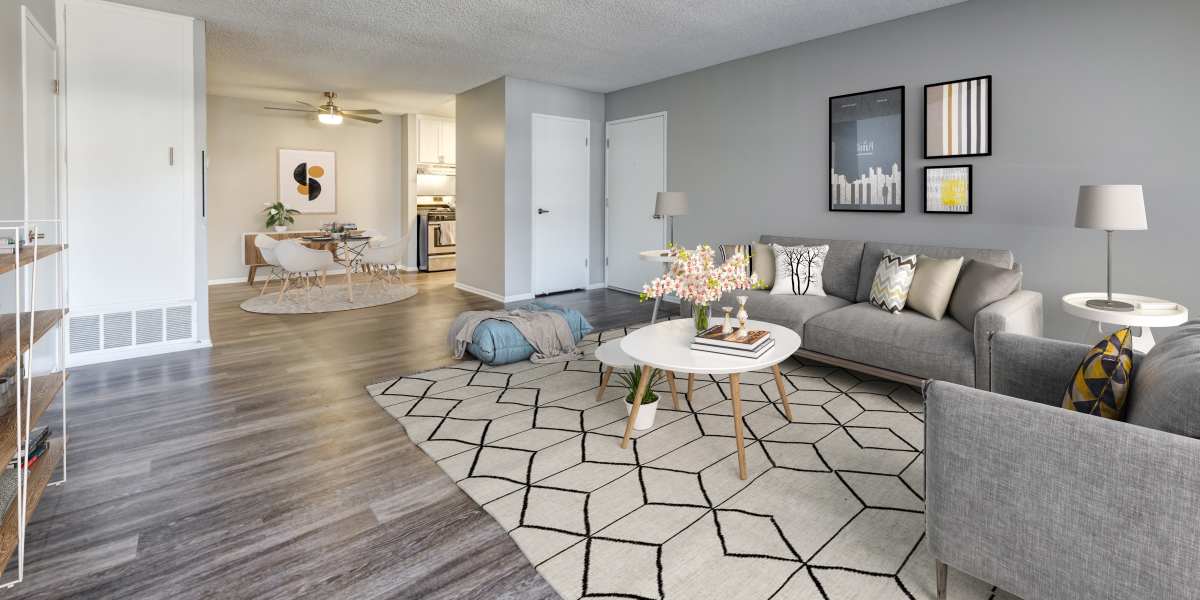 A very large living room with hardwood-style floors at Kendallwood Apartments in Whittier, California