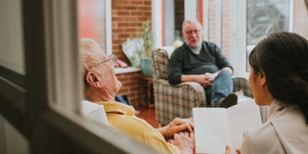 Bible study session led by a caretaker at East Troy Manor in East Troy, Wisconsin