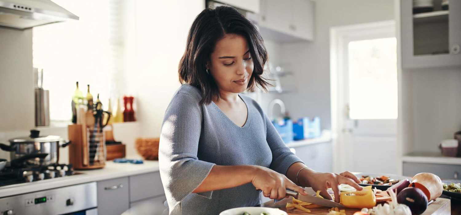 Resident woman preparing food in the kitchen at Carey Chapel Village in Henderson, North Carolina