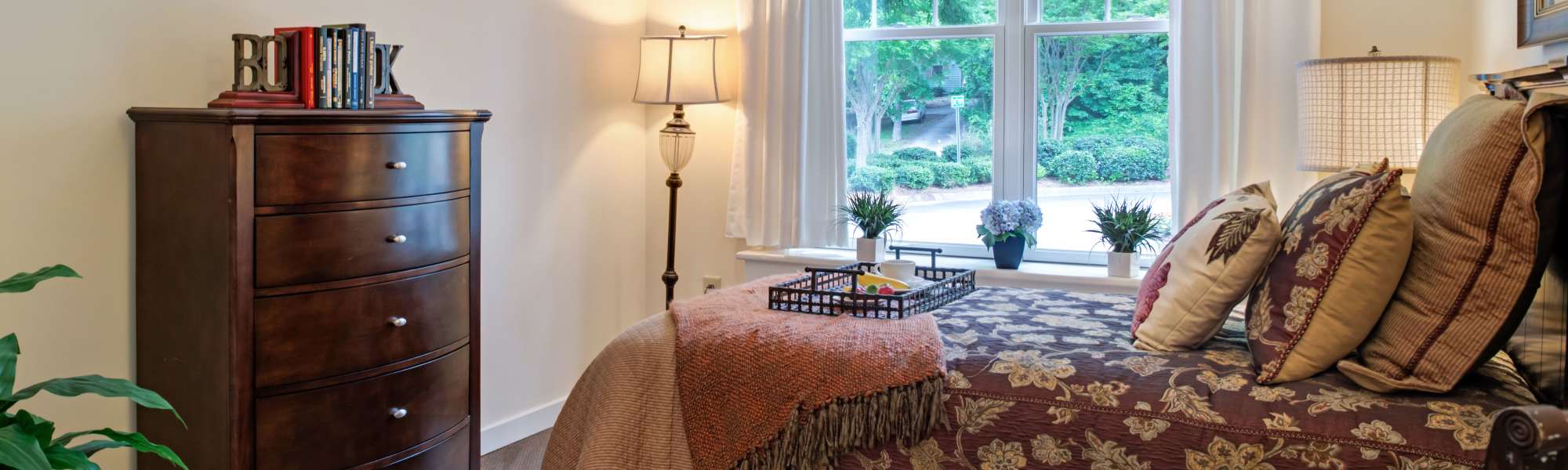 Spacious bedroom with large window and storage unit at Glenncrest at Buckhead in Atlanta, Georgia