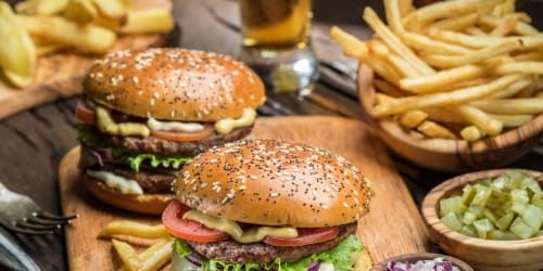 Residents enjoying a burger feast at their favorite restaurant near Xander in Fort Worth, Texas