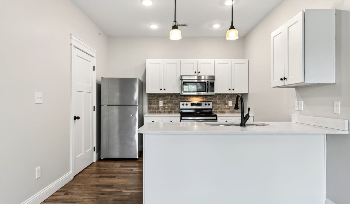 Kitchen with wooden flooring and flat countertop at Palomar Woods in Lexington, Kentucky