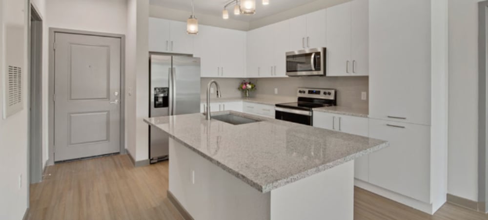 Spacious kitchen with large island at Murano at Three Oaks in Fort Myers, Florida