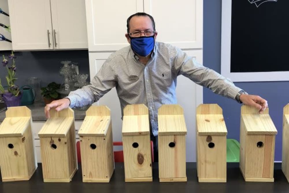 A resident showing handmade birdhouses at Mercer Hill at Doylestown in Doylestown, Pennsylvania