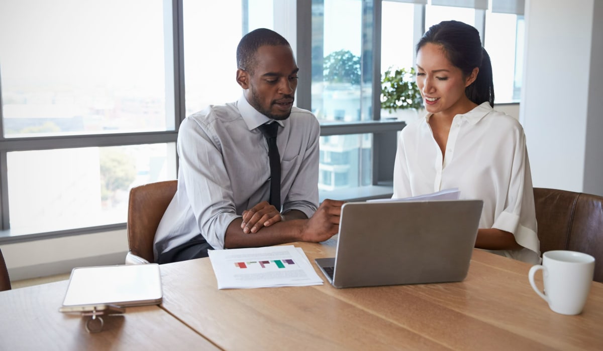  Team mates collaborate in the office at Decron Properties, Los Angeles, California