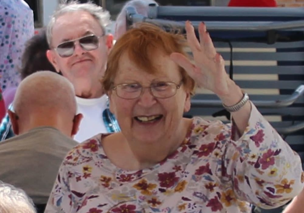 Resident waving to the camera at East Troy Manor in East Troy, Wisconsin