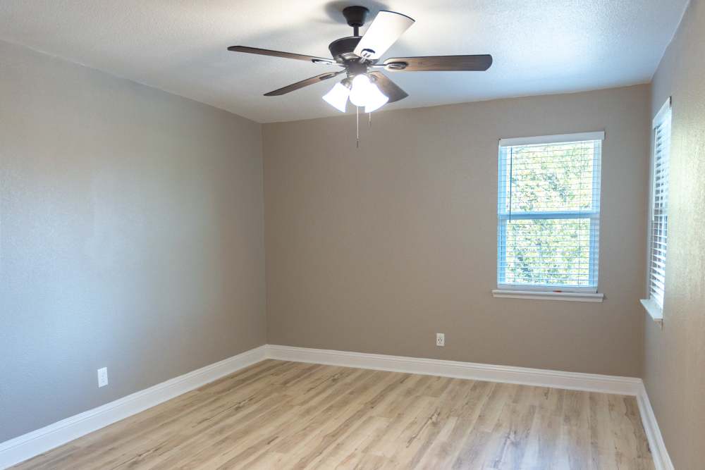 Bedroom with ceiling fan at Lakeshore Villa Apartments in Rowlett,Texas