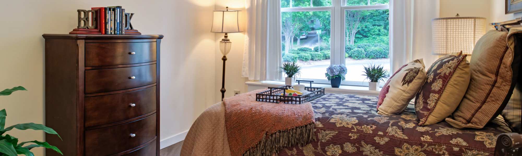 Spacious bedroom with large window and storage unit at Glenncrest at Buckhead in Atlanta, Georgia