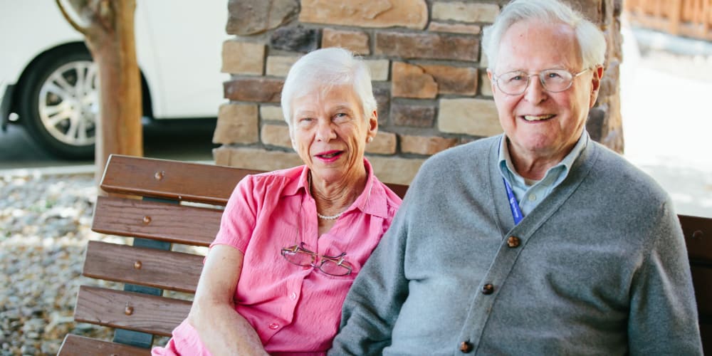 Resident couple sitting outside enjoying the nice day at The Springs at Missoula in Missoula, Montana