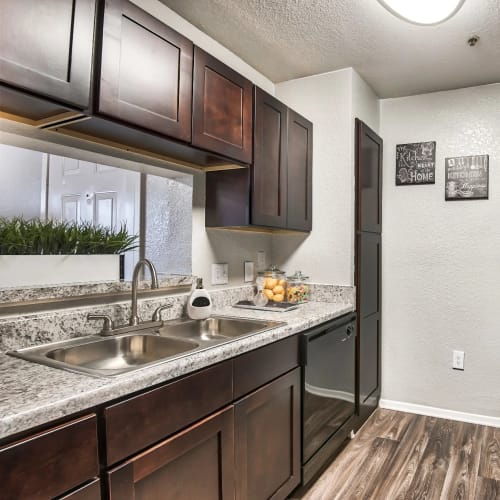 A kitchen counter with a sink and open window space in an apartment at Reserve at Stillwater in Durham, North Carolina