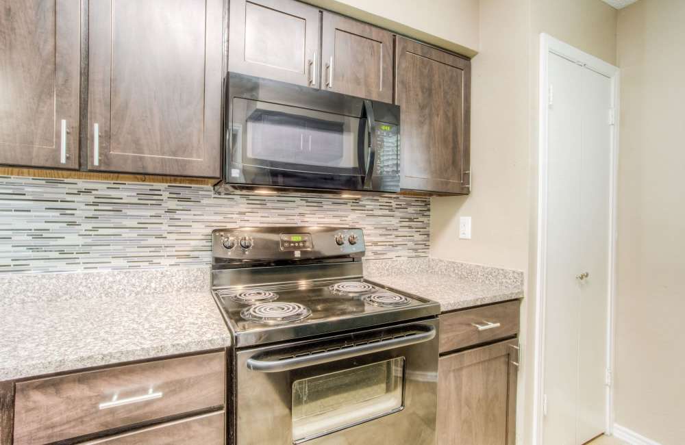 Apartment kitchen with modern appliances at The Quorum At Trophy Club in Trophy Club, Texas