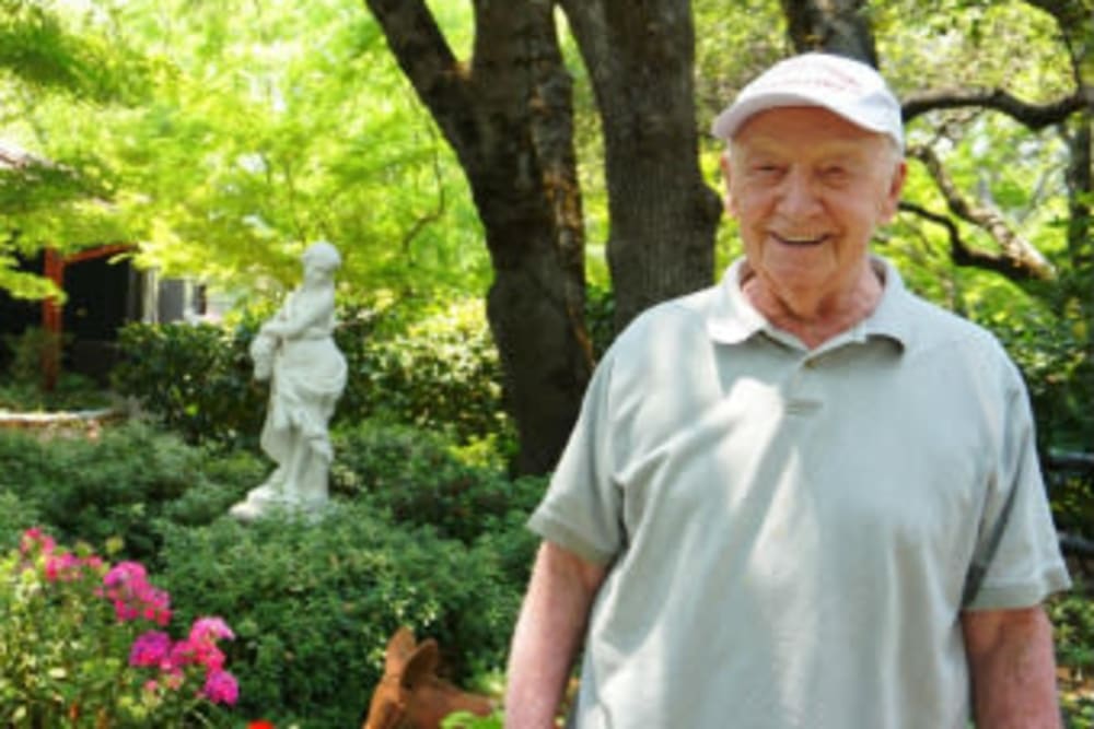 Resident enjoying the great landscaping at Campus Commons Senior Living in Sacramento, California