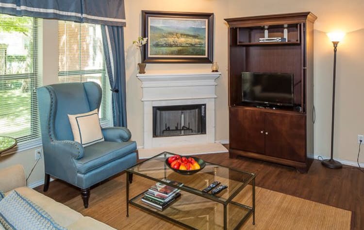 Spacious kitchen with wood flooring and a fireplace at Ranch ThreeOFive in Arlington, Texas