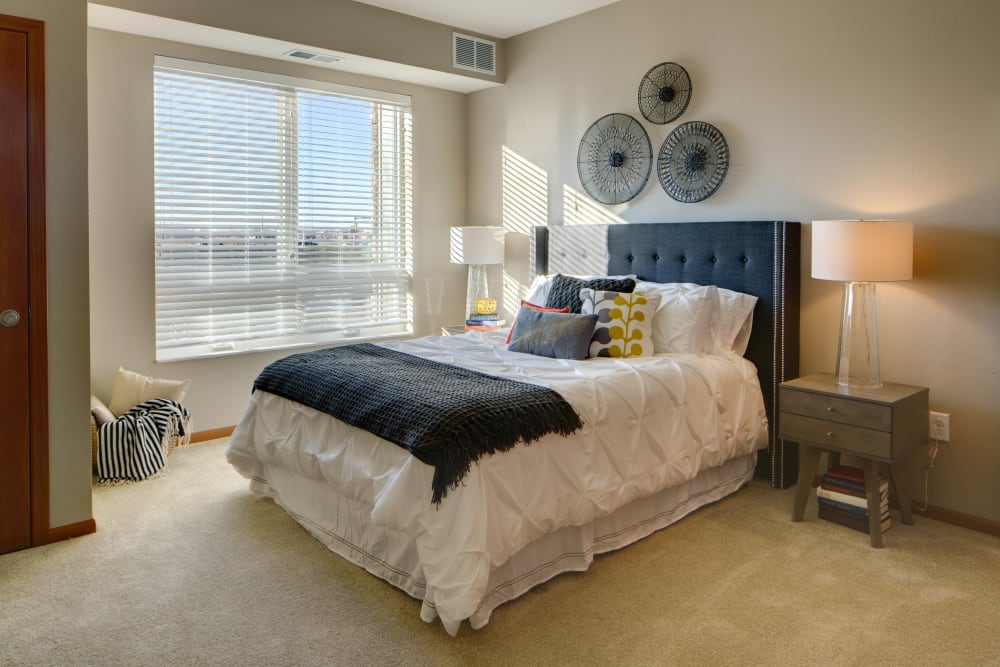 Spacious main bedroom with a large window for natural lighting at Remington Cove Apartments in Apple Valley, Minnesota