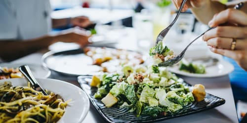 Residents enjoying a salad feast at their favorite restaurant near Xander in Fort Worth, Texas