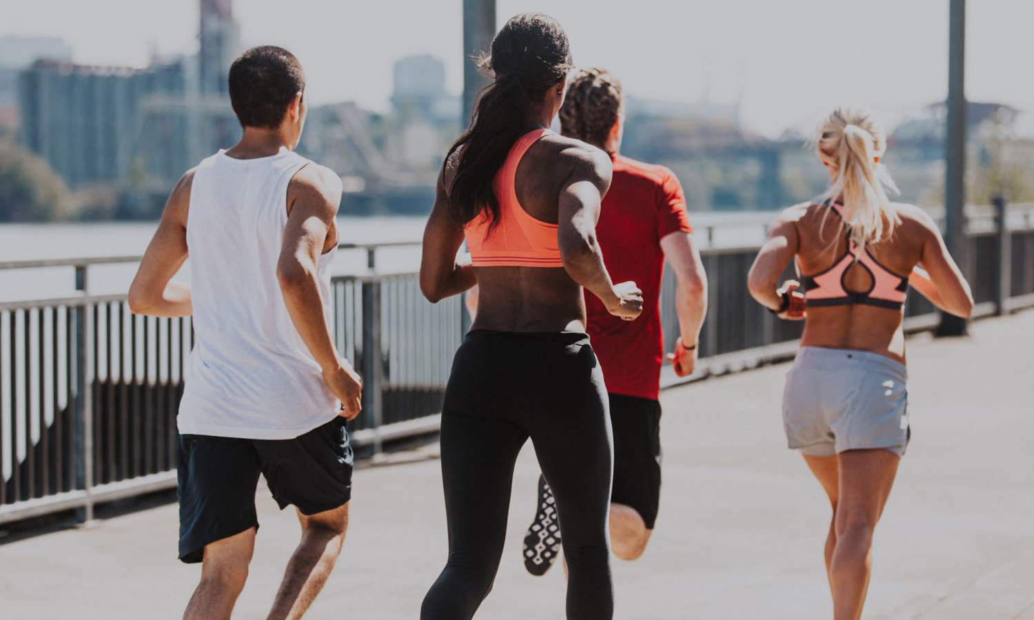 Four people jogging along a waterfront path near Ardmore & Twenty Eighth in Atlanta, Georgia 
