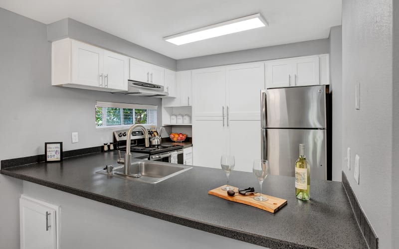 Renovated kitchen with white cabinets at Park South Apartments in Seattle, Washington