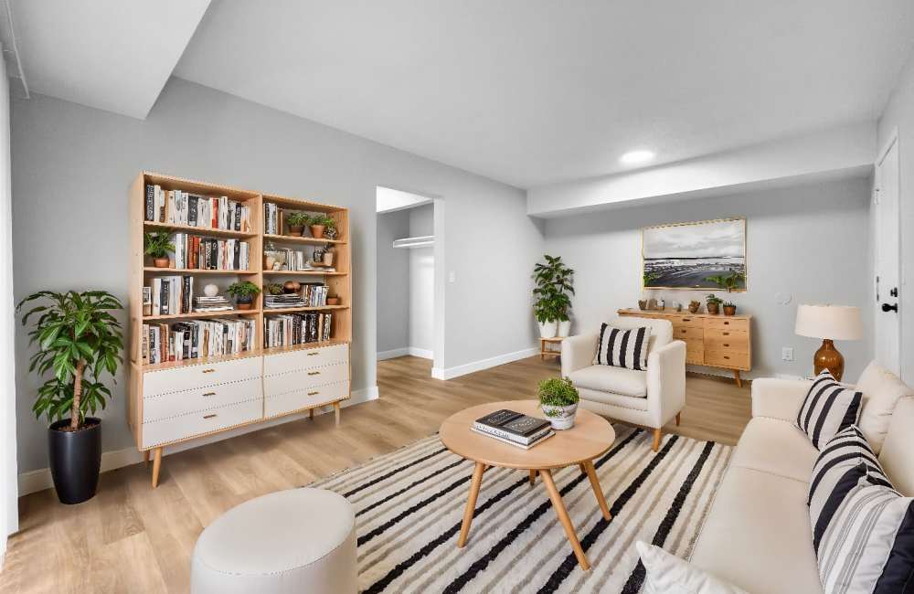 Living room with book shelf and access to closet at Rock Ridge Commons in Moline, Illinois