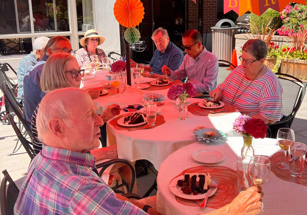 Residents celebrating a birthday outdoors at Merrill Gardens at The University in Seattle, Washington