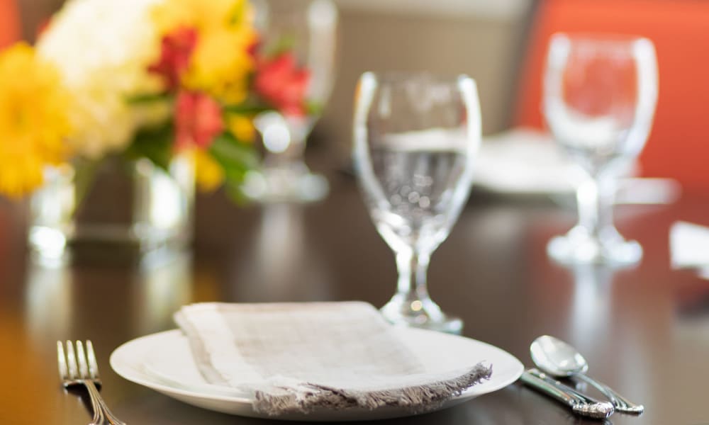 Dining room table with place setting and fresh flowers at Randall Residence at Gateway Park in Greenfield, Indiana