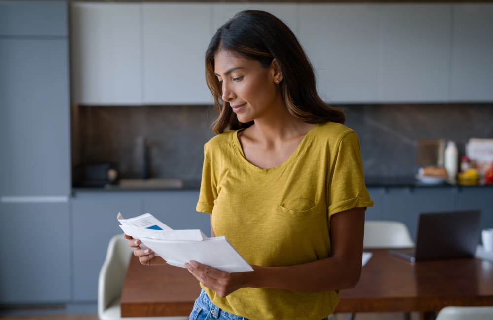 A woman looking through her mail in her kitchen at Dunwoody Exchange in Atlanta, Georgia