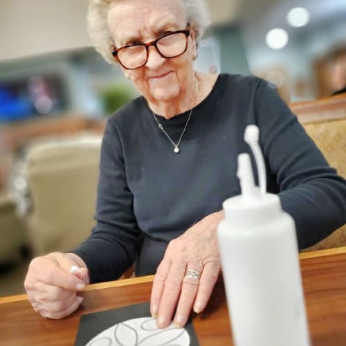 A resident doing an art project at Glen Carr House Memory Care in Derby, Kansas